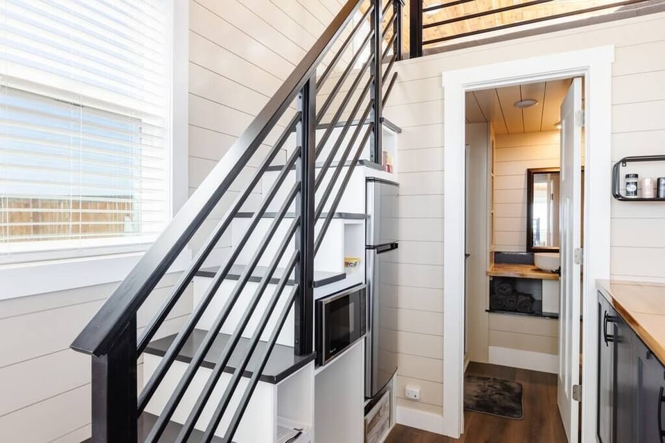 The kitchen is equipped with a refrigerator, freezer, microwave, cooktop, and sink with hot/cold water. Enjoy coffee from the coffee maker and ample counter space. Essentials include cookware, dishes, utensils, and storage cabinets.
