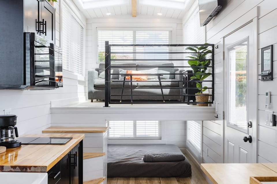 Relax in the inviting living room featuring a comfortable couch and a TV for entertainment. Stay connected with Wi-Fi access, making this space perfect for unwinding or enjoying your favorite shows and movies.