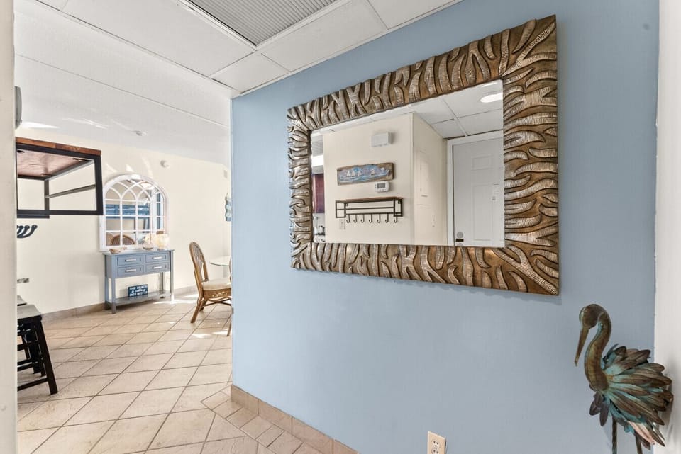 Welcoming entry hallway with coastal décor and easy access to the living and dining areas.