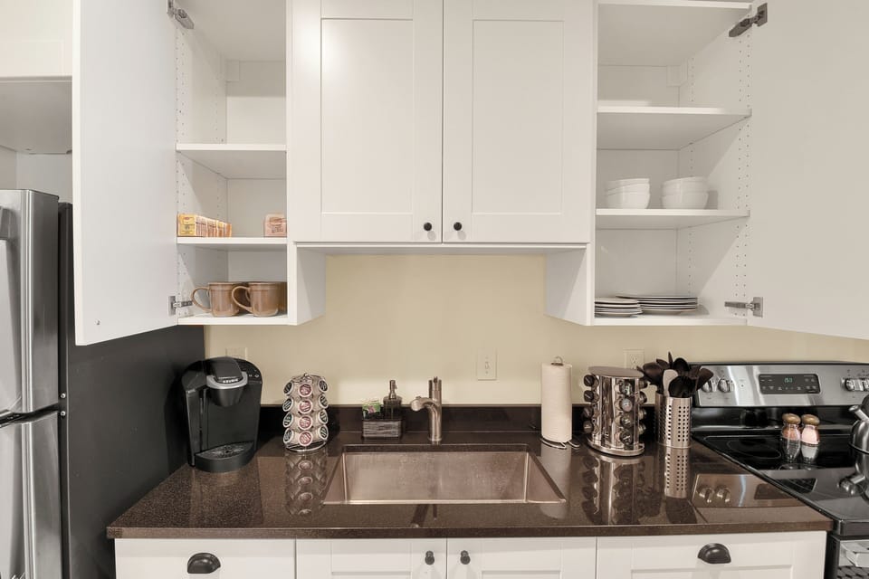 Dinnerware, Keurig machine with coffee/tea provide, cooking utensils.