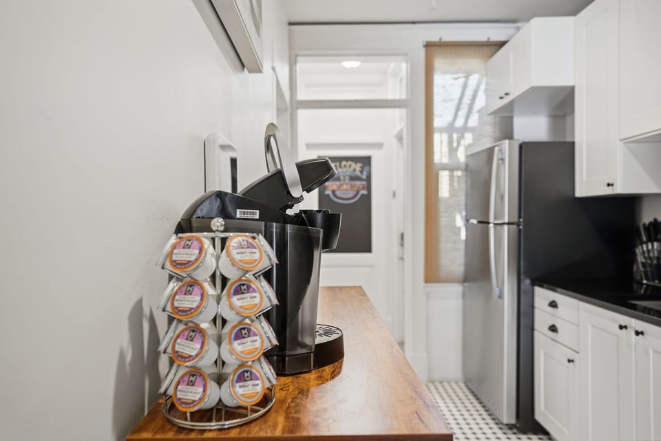 Coffee bar with Keurig coffee maker, variety of complimentary K-cups, and teas.