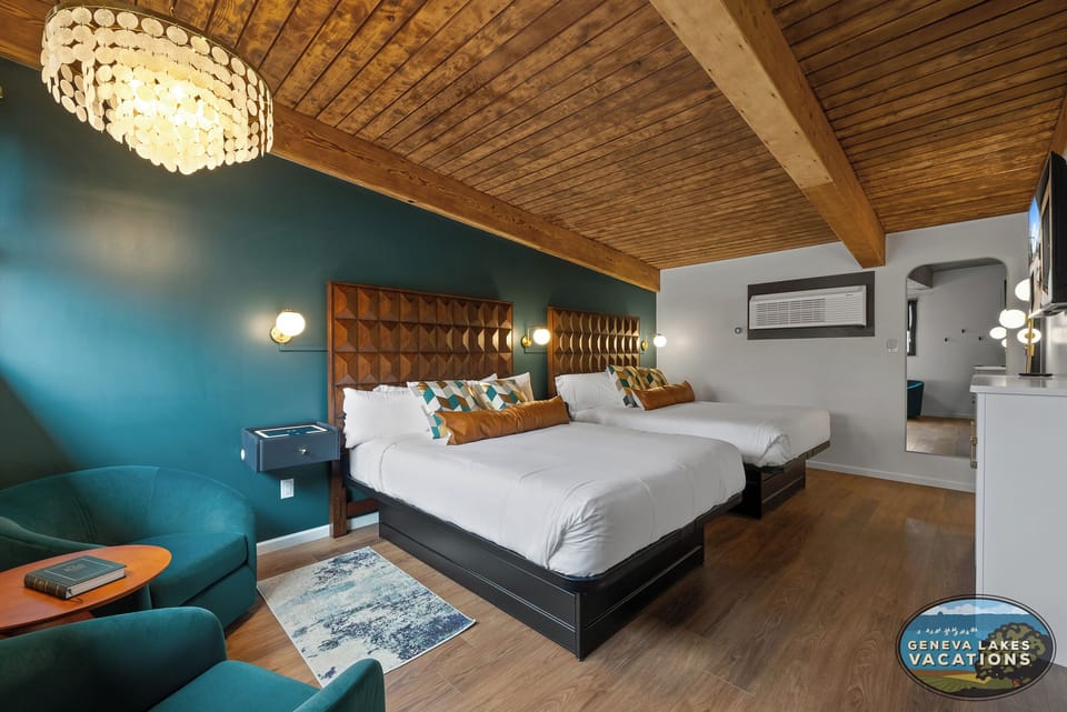 Two Queen Beds, seating for two. Nightstands are lit USB port, surface charging.