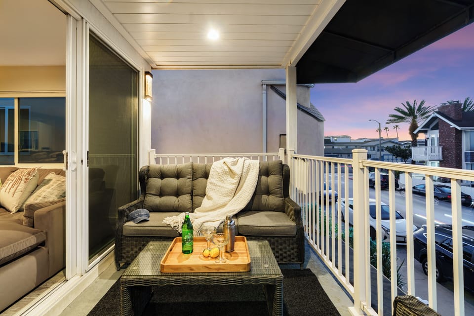 Private upper-level balcony with comfortable seating, perfect for morning coffee or evening wind-down.