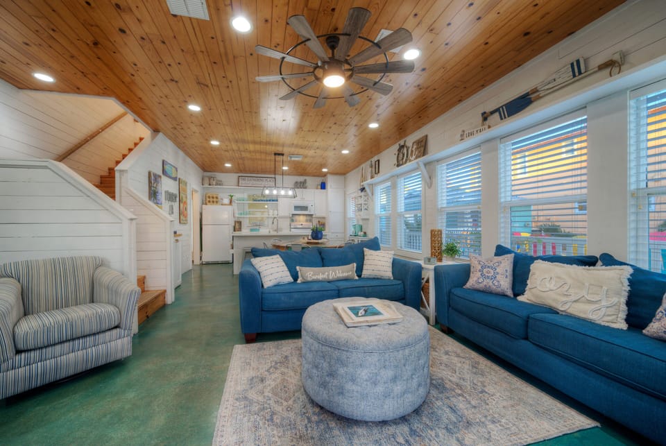 Bright, coastal-inspired living space with vaulted wood ceilings—perfect for gathering, relaxing, and unwinding after a day at the beach.