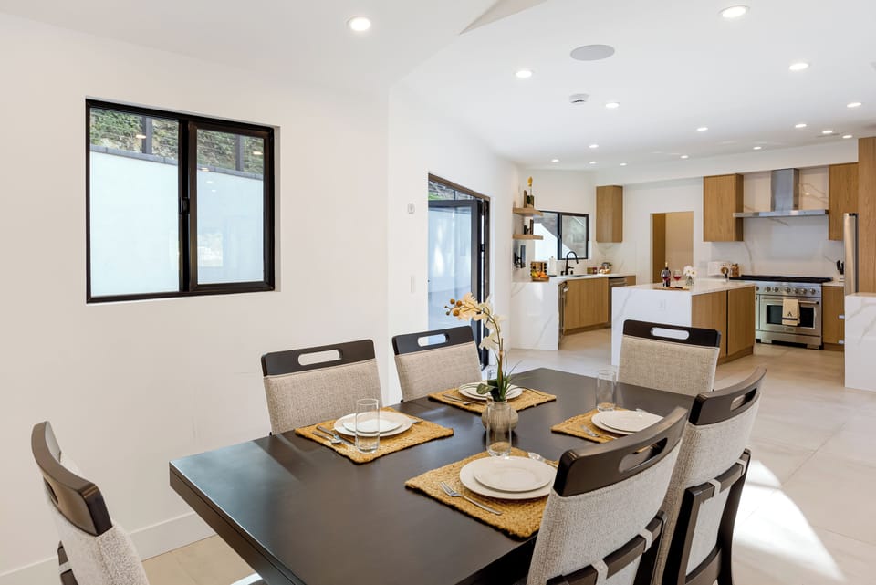 A bright, modern dining space designed for shared meals and easy conversation, with seating for six in a clean, contemporary setting.