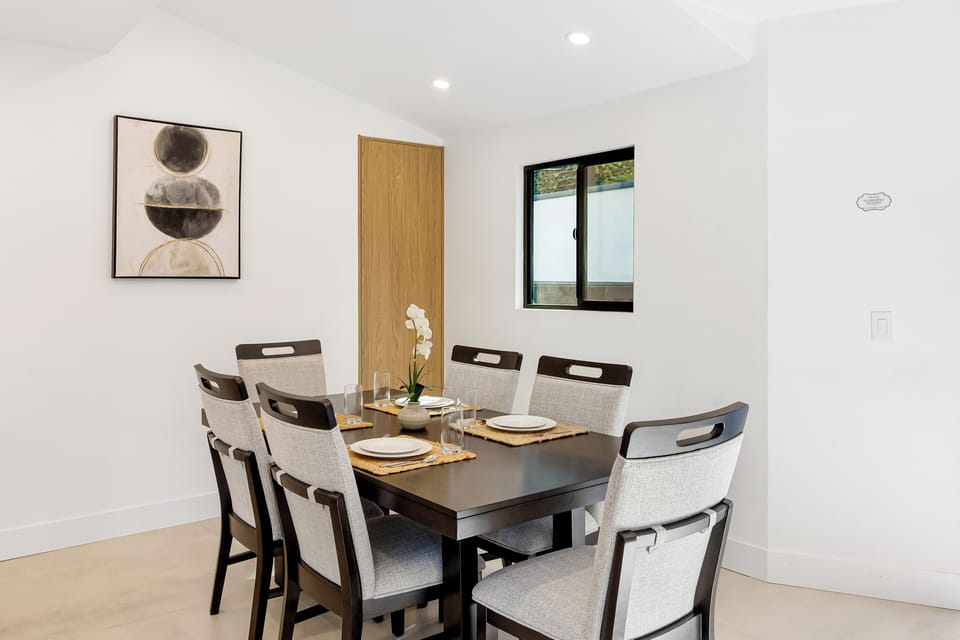 A bright, modern dining space designed for shared meals and easy conversation, with seating for six in a clean, contemporary setting.