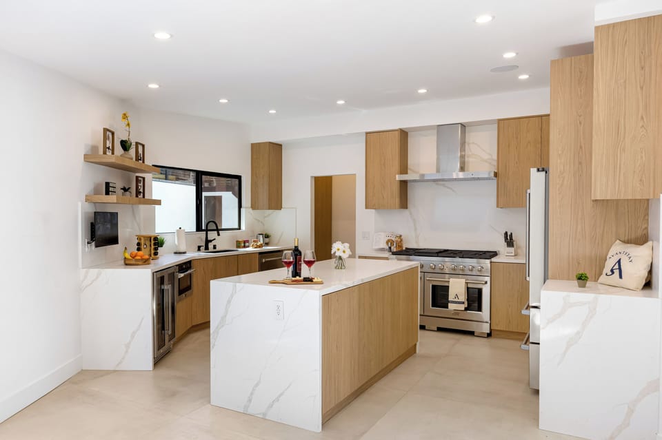 Sleek, modern kitchen with a spacious island, premium appliances, and clean-lined finishes—perfect for cooking, gathering, and casual meals.