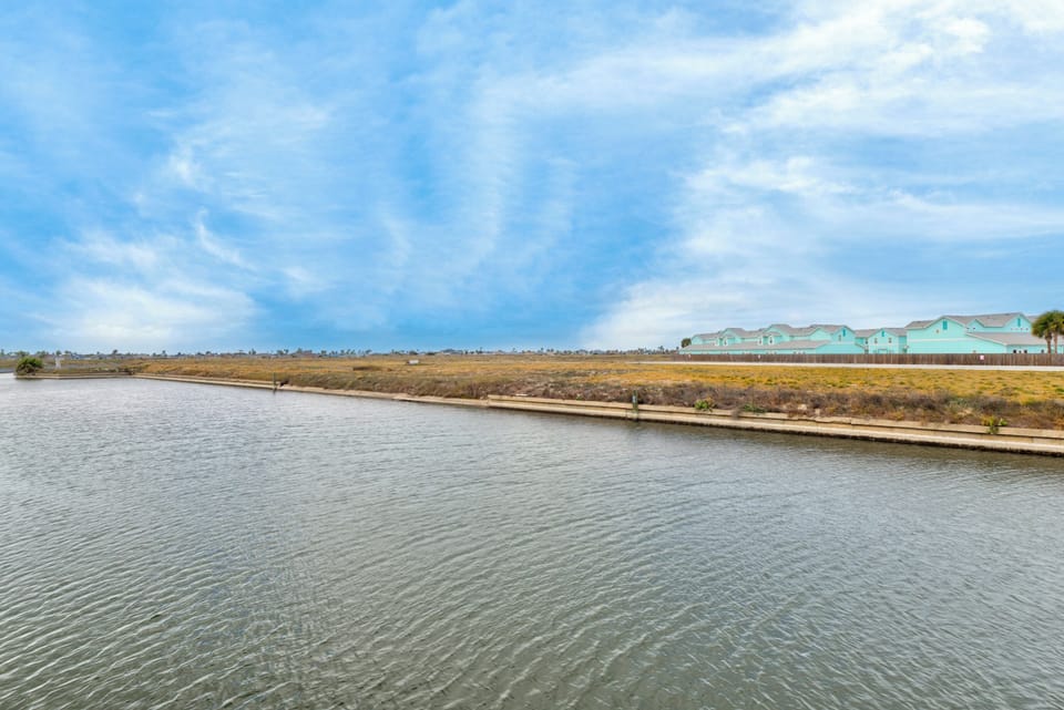 Waterfront location with peaceful canal views and charming coastal homes dotting the horizon.