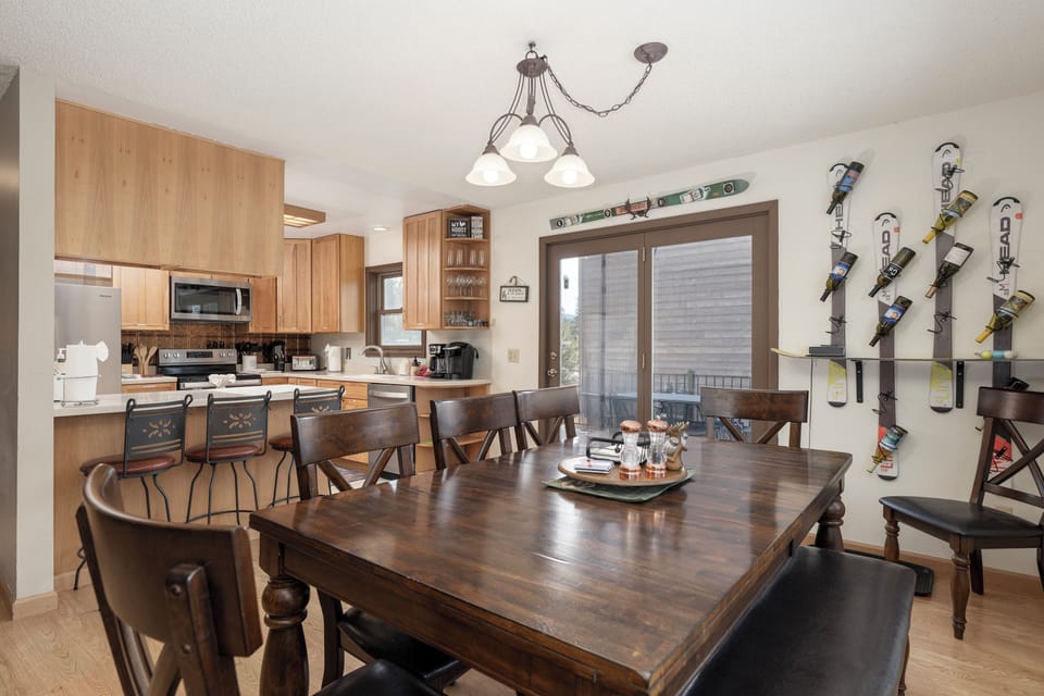 Gather around this spacious dining table at 874 Kinnikinnick Road where your group can share meals and plan mountain adventures in this fully-equipped kitchen space.