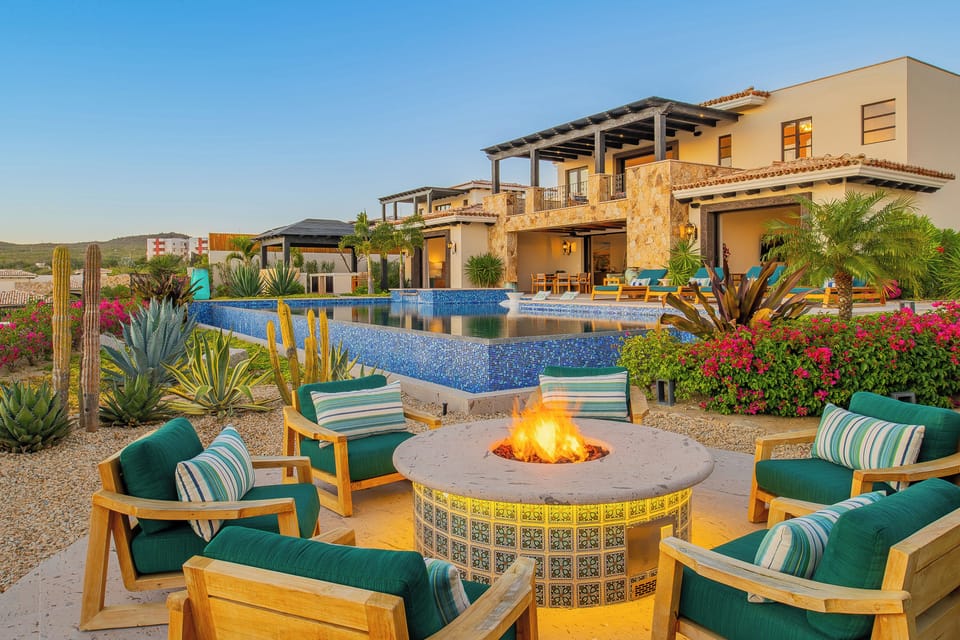 Stunning villa with desert fire pit and infinity pool creates the perfect evening retreat in tropical paradise.