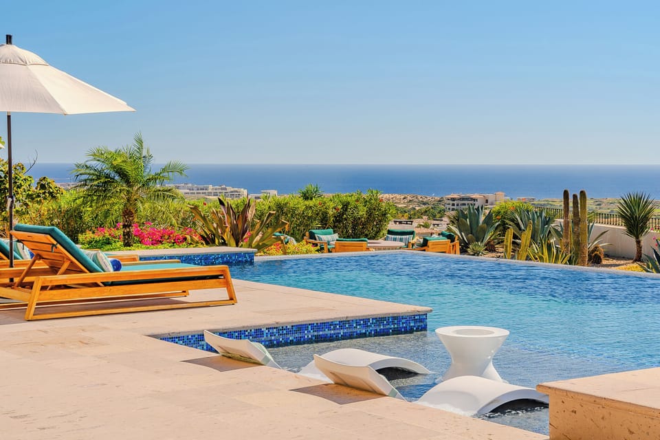 Dive into paradise at your private pool with sweeping sea views and desert garden backdrop.