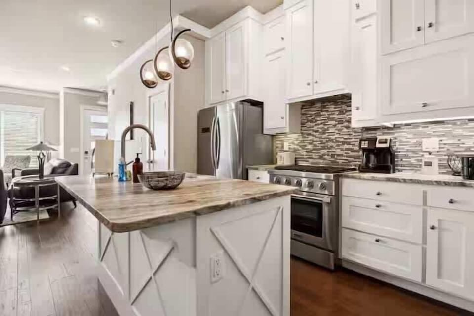 Spacious kitchen and dining space with pendant lighting and stylish finishes.