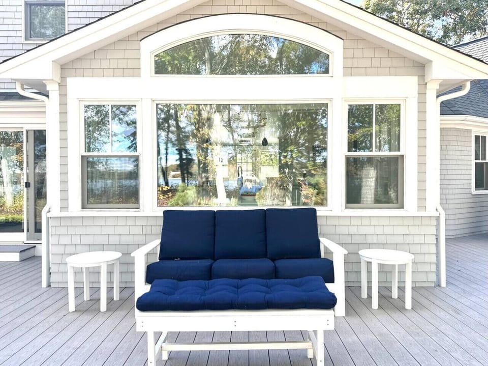 Outdoor lounge and furniture facing the water and nature
