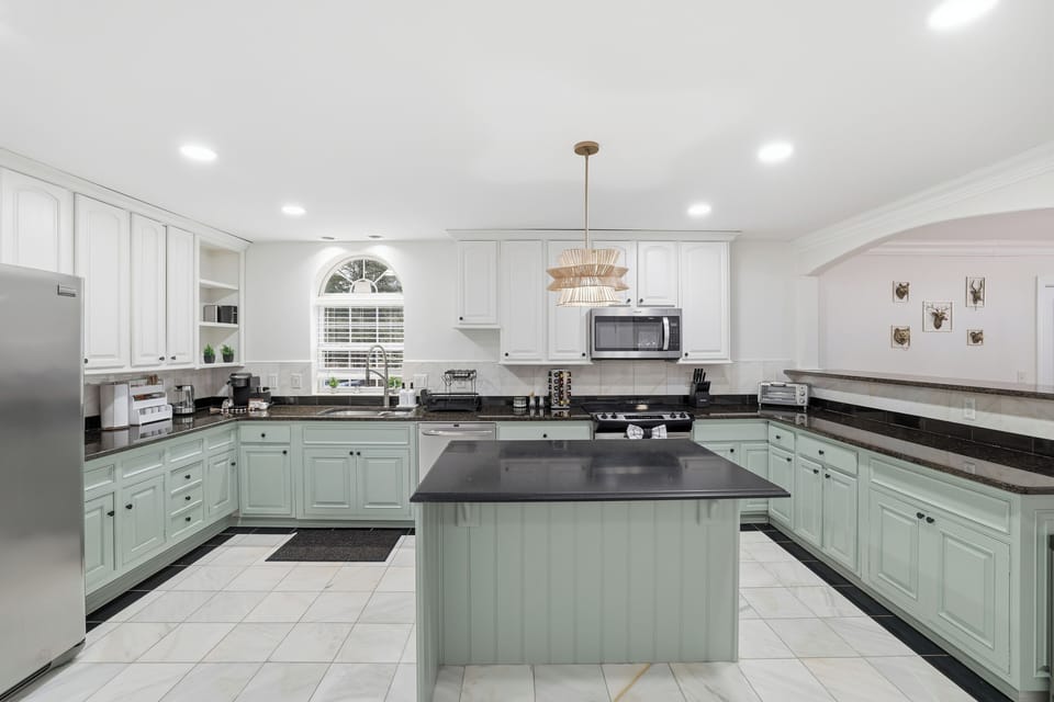 Bright, modern kitchen with spacious island and stainless steel appliances.