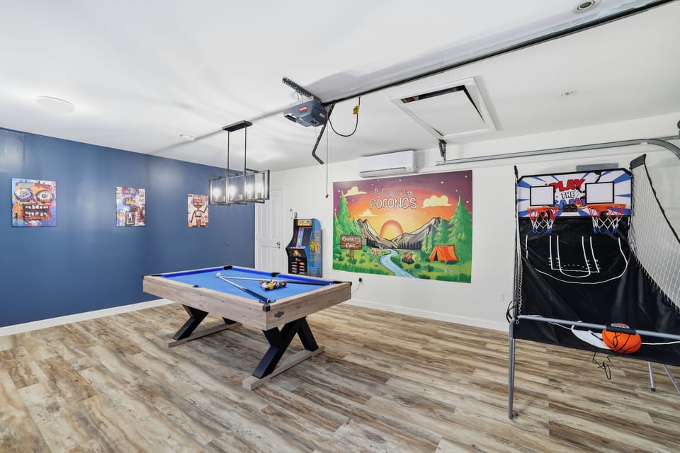 Entertainment-packed game room with pool, arcade & hoops