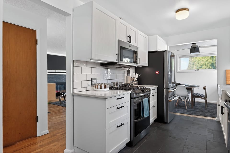 Bright modern kitchen with gas range, subway tile, and cozy dining nook