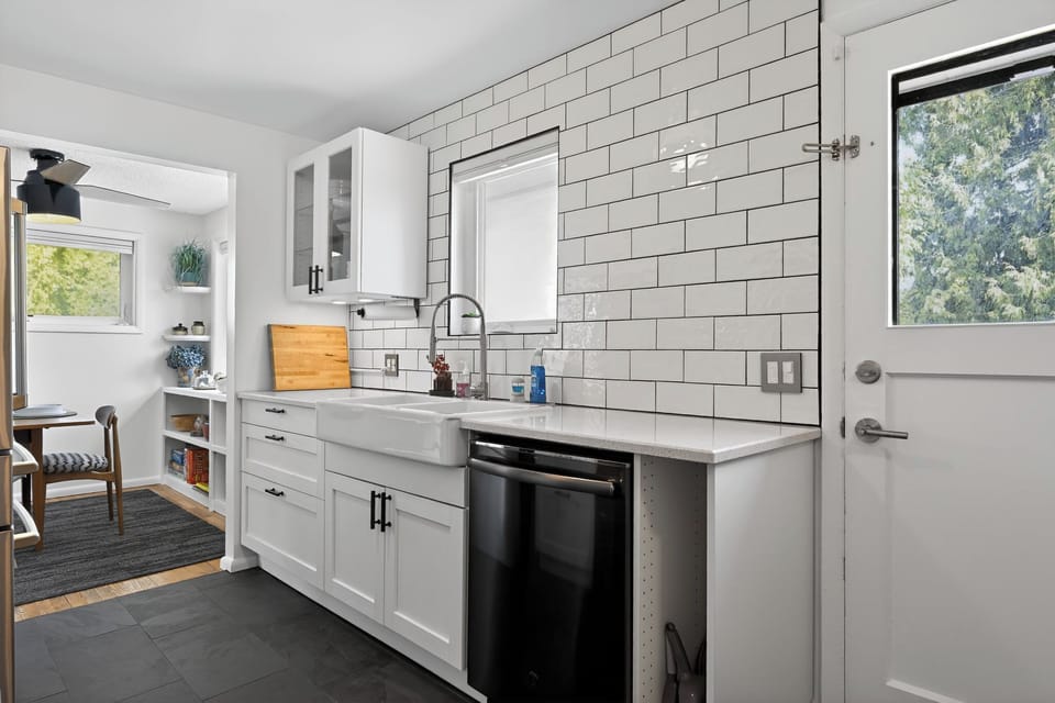 Bright kitchen with subway tile, farmhouse sink, and breakfast nook