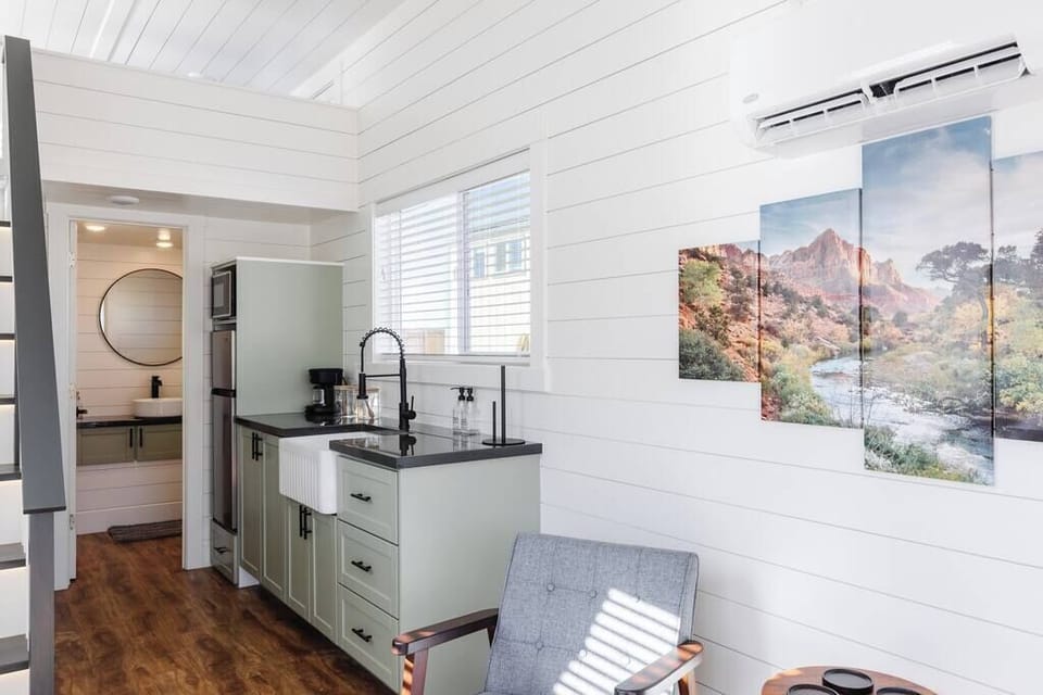 Relax in the inviting living room featuring comfortable chairs and a TV for entertainment. Stay connected with Wi-Fi access, making this space perfect for unwinding or enjoying your favorite shows and movies.