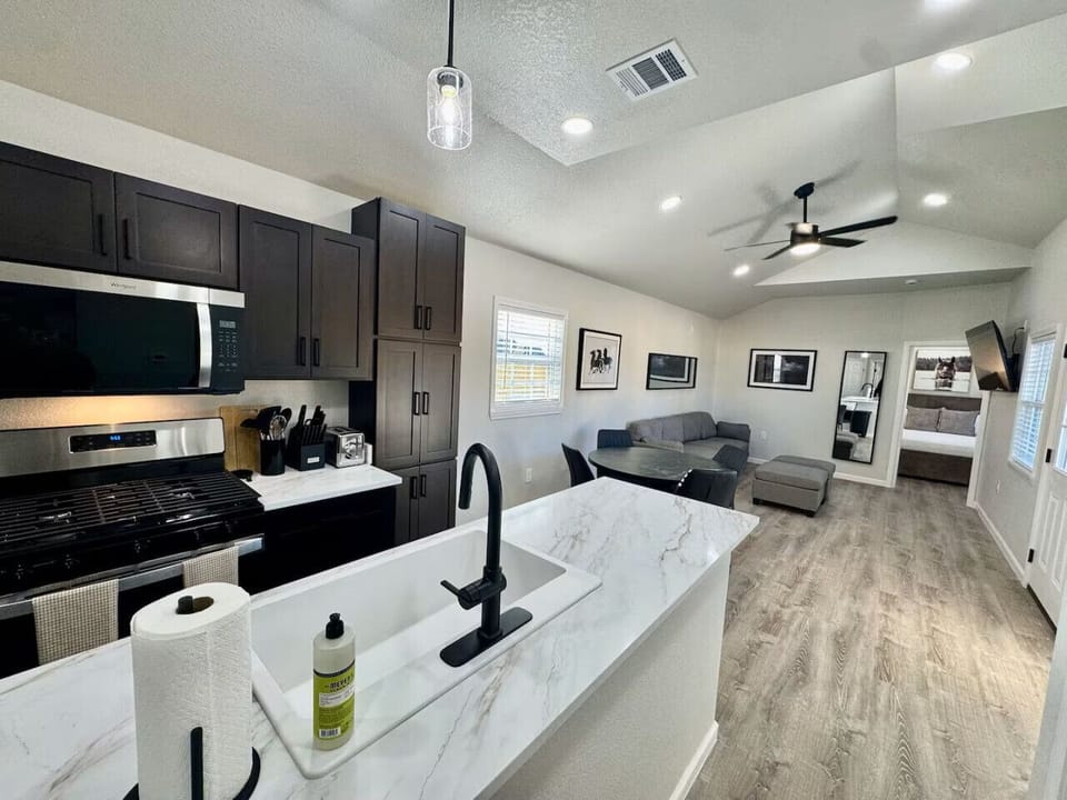 Tiny House features a functional kitchen with essential appliances and amenities for easy meal preparation.