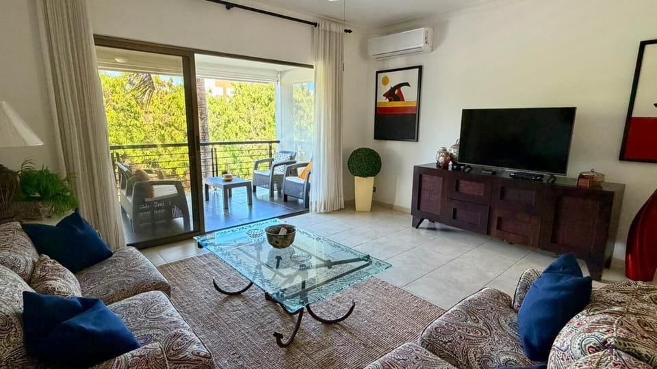 Ample and breezy living room with direct balcony access.