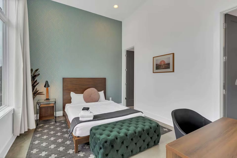 Bedroom 1 w/ queen bed, desk, walk-in closet + en-suite bath | Unit C
