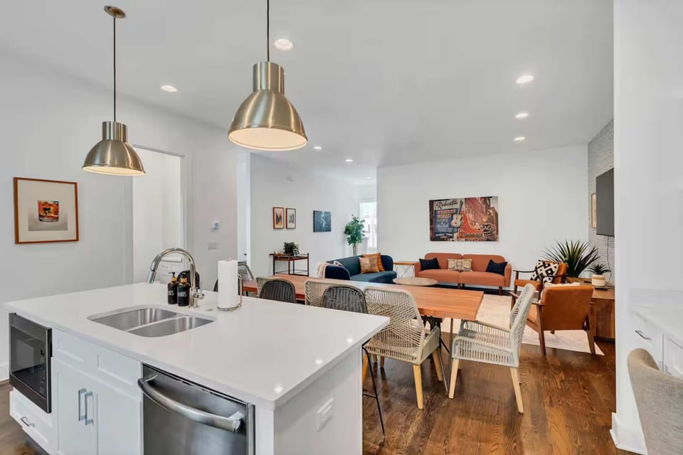 Open-concept kitchen with quartz counters, gas range, and stainless appliances.