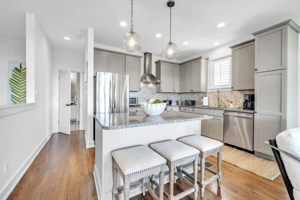The fully equipped kitchen features island seating for three.