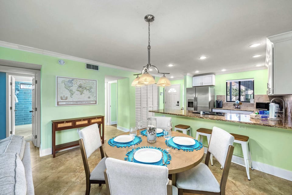 Open-Concept Living & Dining – Formal dining table with seating for four, additional breakfast bar stools for even more flexible seating