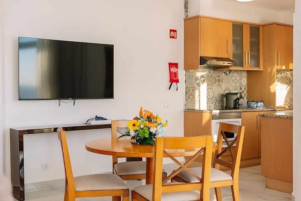 Gather for easy meals with kitchen convenience close by.