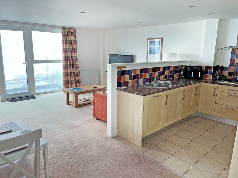 Lounge, Kitchen, Dining area with views of Fistral beach | Flat 2, Newquay