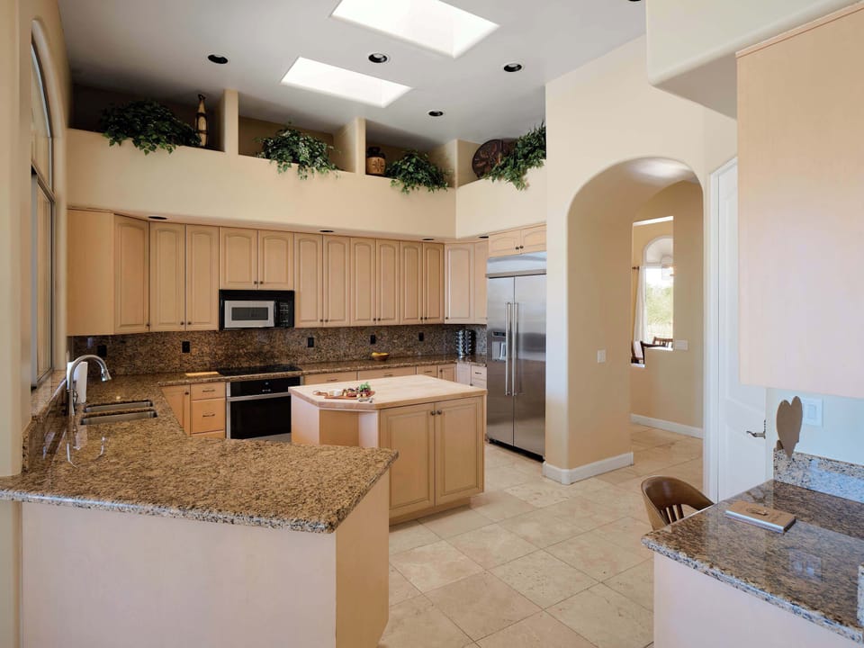 Fully equipped kitchen with stainless steal appliances, a kitchen island, ample counter space, dedicated work space, and breakfast nook.
