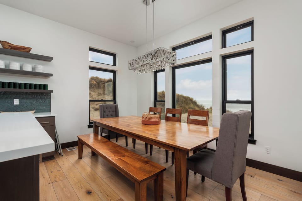 Your sun-filled dining space features a stunning wood table and bench, perfect for memorable meals together.