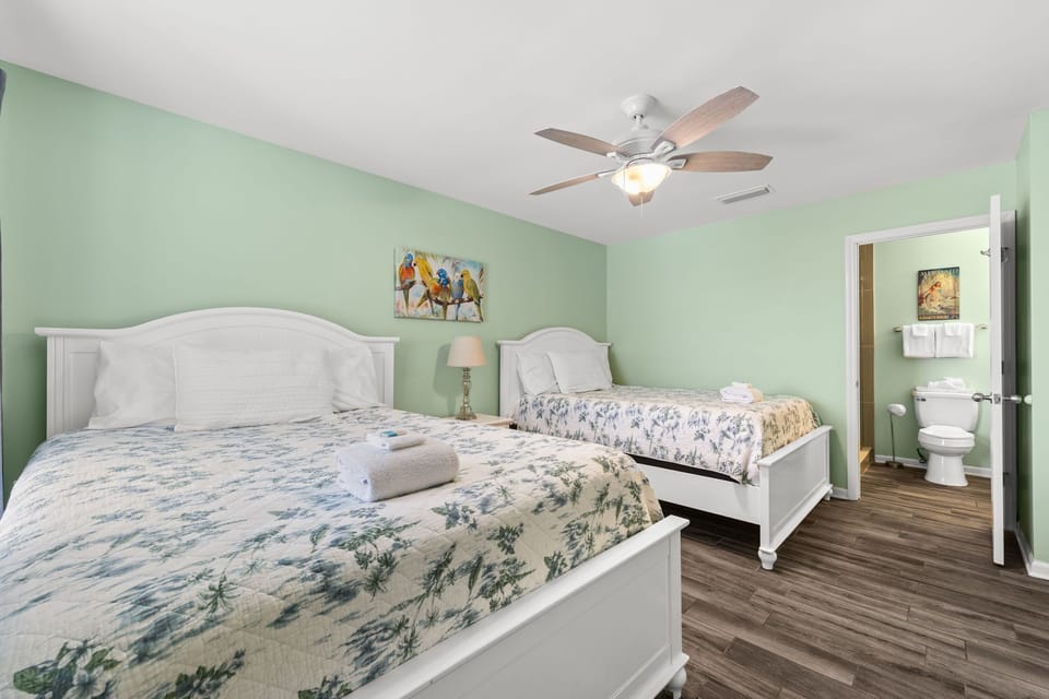 Cheerful bedroom w/ natural light, cozy bedding & a relaxed vibe perfect for recharging.