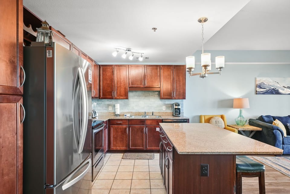 Modern kitchen with stainless steel appliances and a large island for dining and meal preparation