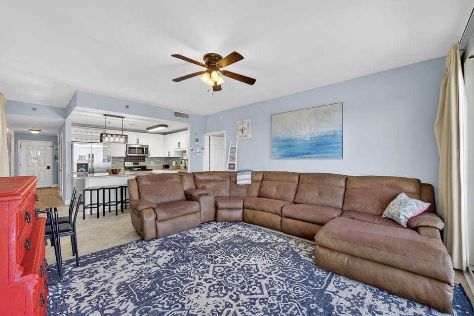 Spacious living room with a large sectional sofa and open kitchen layout