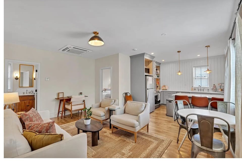 Open concept living room with desk area, breakfast table nook, and more. 