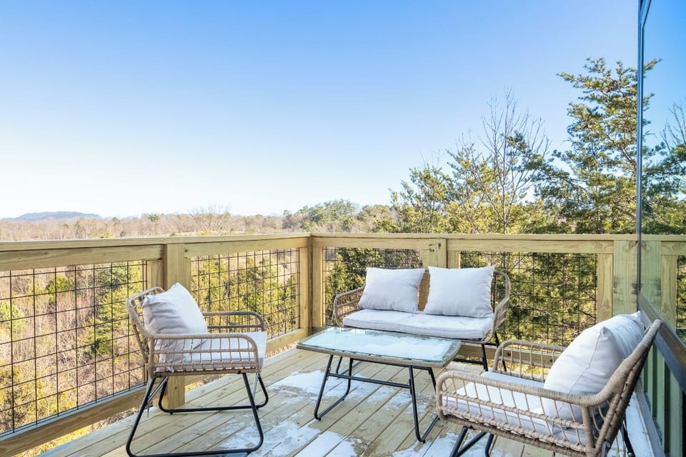 Relax on your private deck with stunning mountain views, where comfortable seating and fresh air create the perfect morning coffee spot.