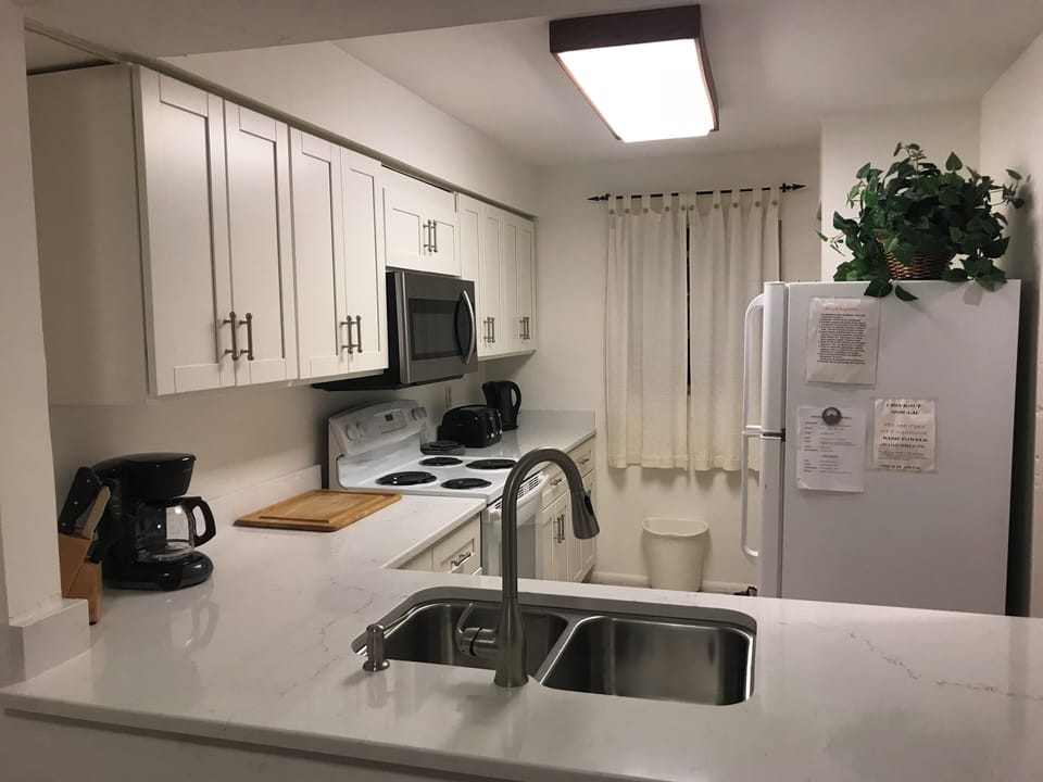 View of the Kitchen from Dining area and Countertop is a Serving table area