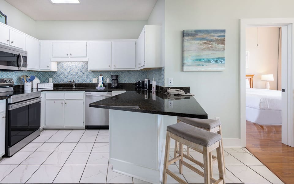Craft delicious meals in the inviting kitchen while sharing laughter at the comfy counter stools nearby