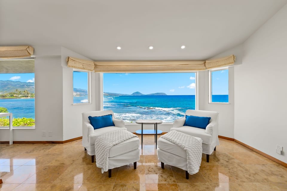 Settle into your private seating nook with stunning ocean panoramas through expansive windows—your perfect spot for morning coffee.