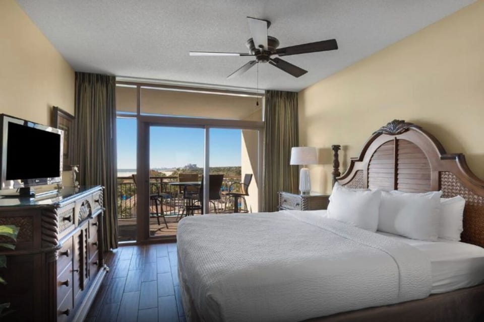 Wake up to sunshine and balcony views from bed.