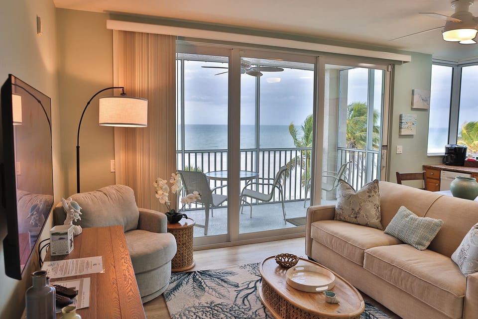 Living area with sliding glass doors fully opening to the lanai.