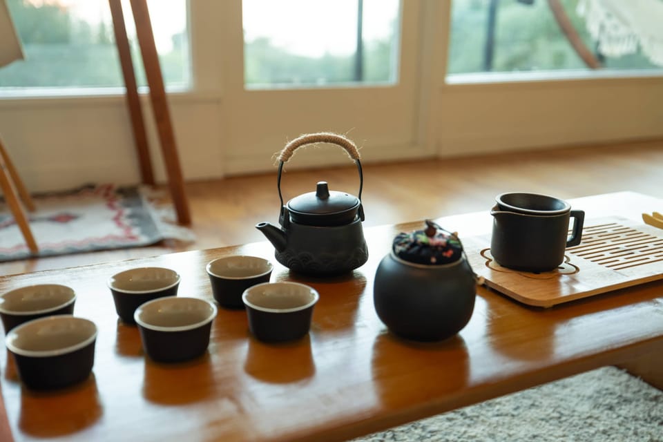 A thoughtfully arranged tea set on a warm wood table creates a calming ritual space, perfect for slow mornings, quiet conversations, or peaceful afternoons by the window