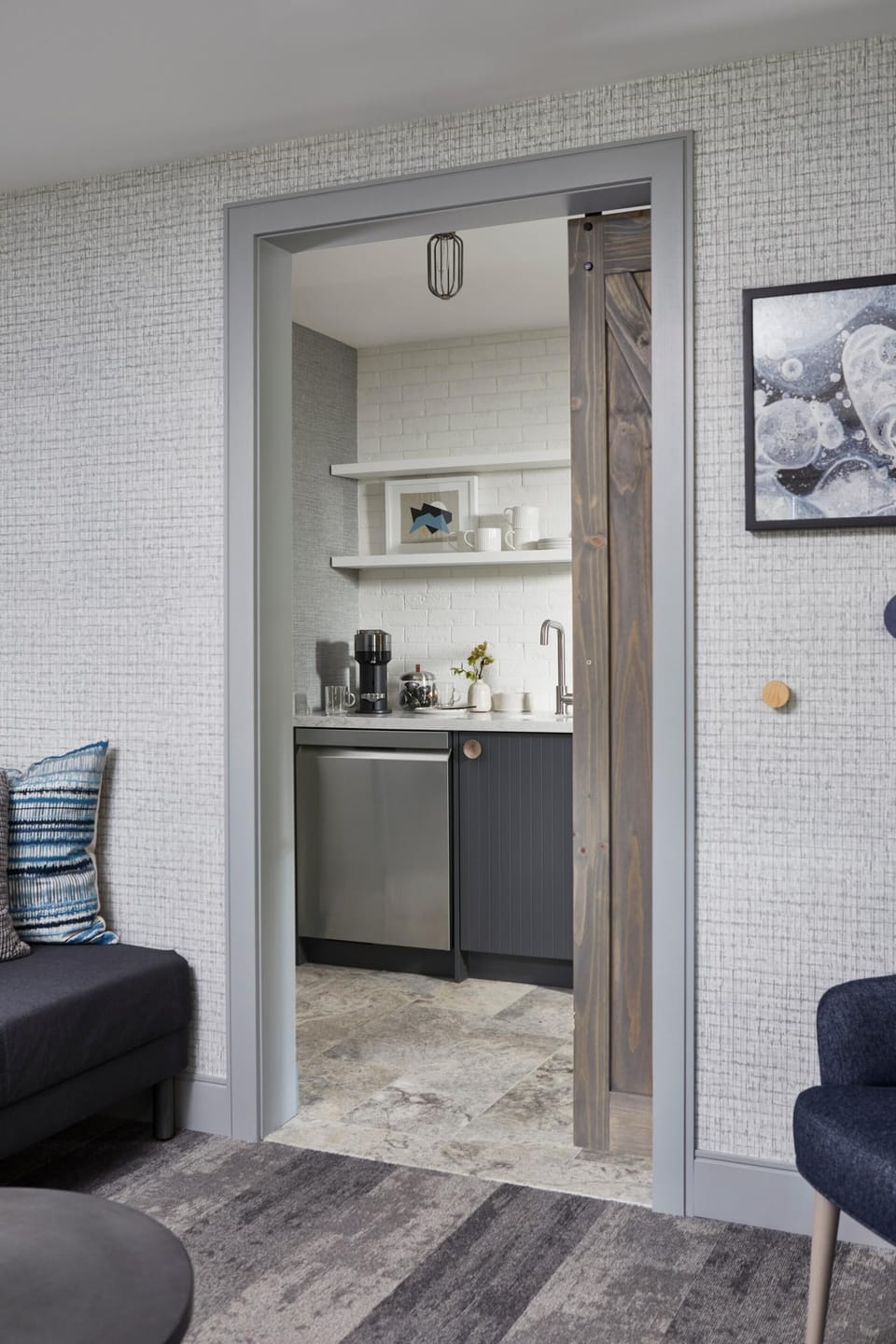 Easy access to the bar area with fridge, dishwasher, and coffee machine from the movie room.