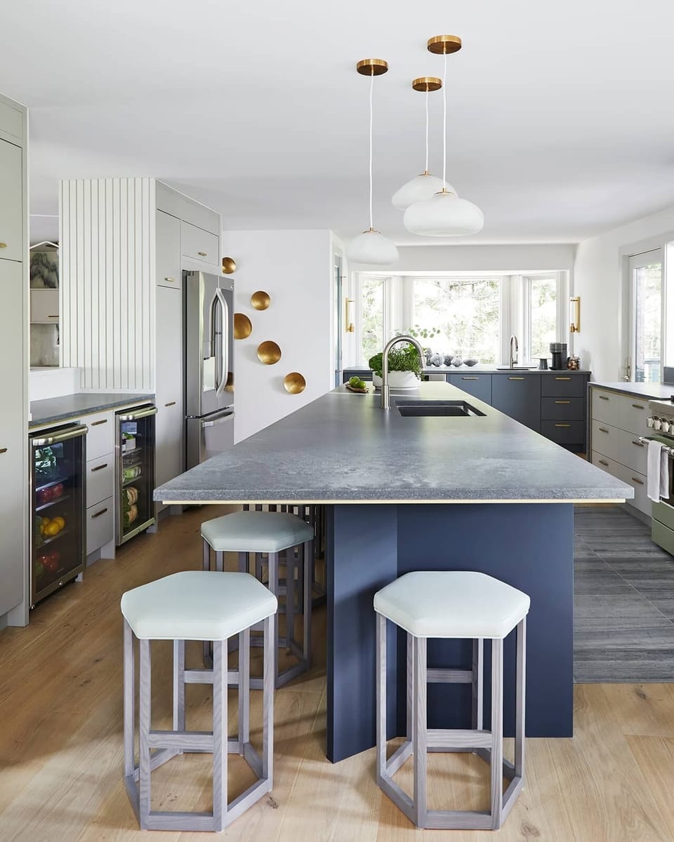 The asymmetrical island is a central gathering place with 6 barstool seats