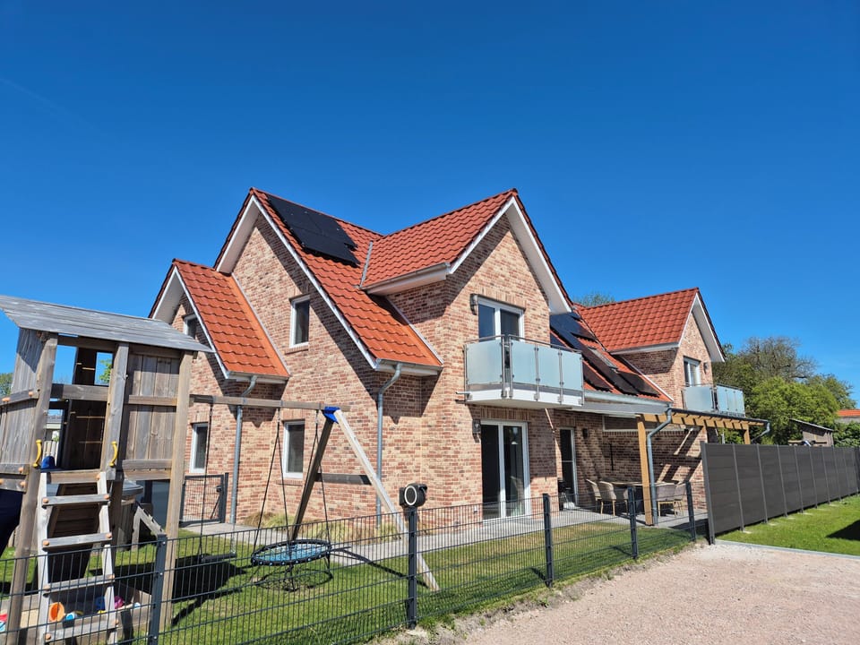 Exterior view of a modern holiday home with playground