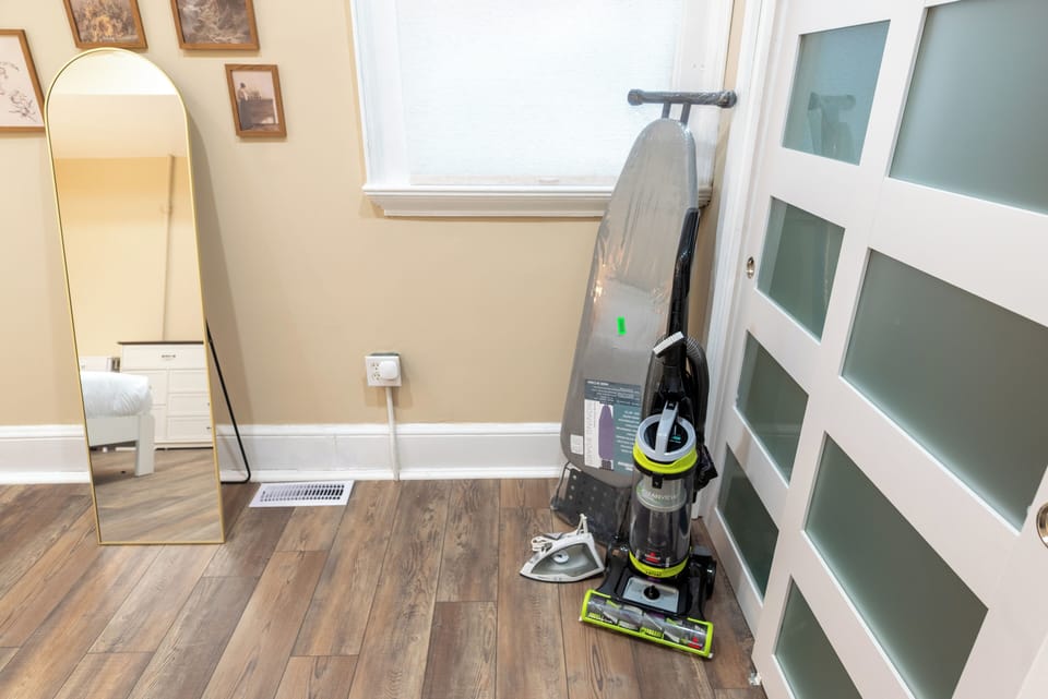 Fully equipped for longer stays with a high-quality vacuum, iron, and ironing board.