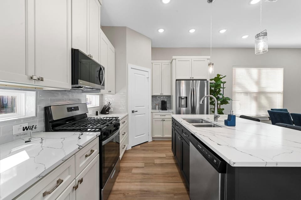 Fully stocked Kitchen with island and appliances overlooking dining and living .