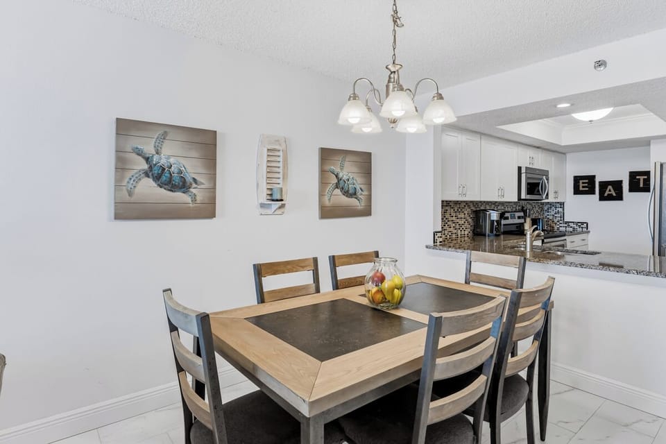 Gather around your stylish dining table for memorable meals, with coastal artwork setting a relaxing tone and your fully equipped kitchen just steps away.