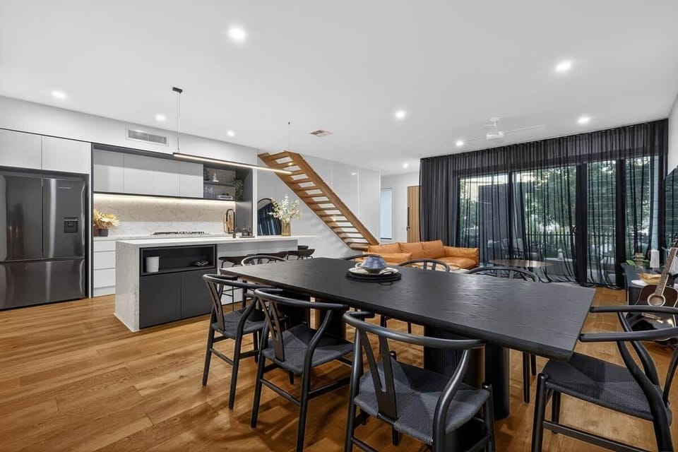 Featuring dark American oak and wide legs, the dining table delivers a luxurious, modern space to come together.